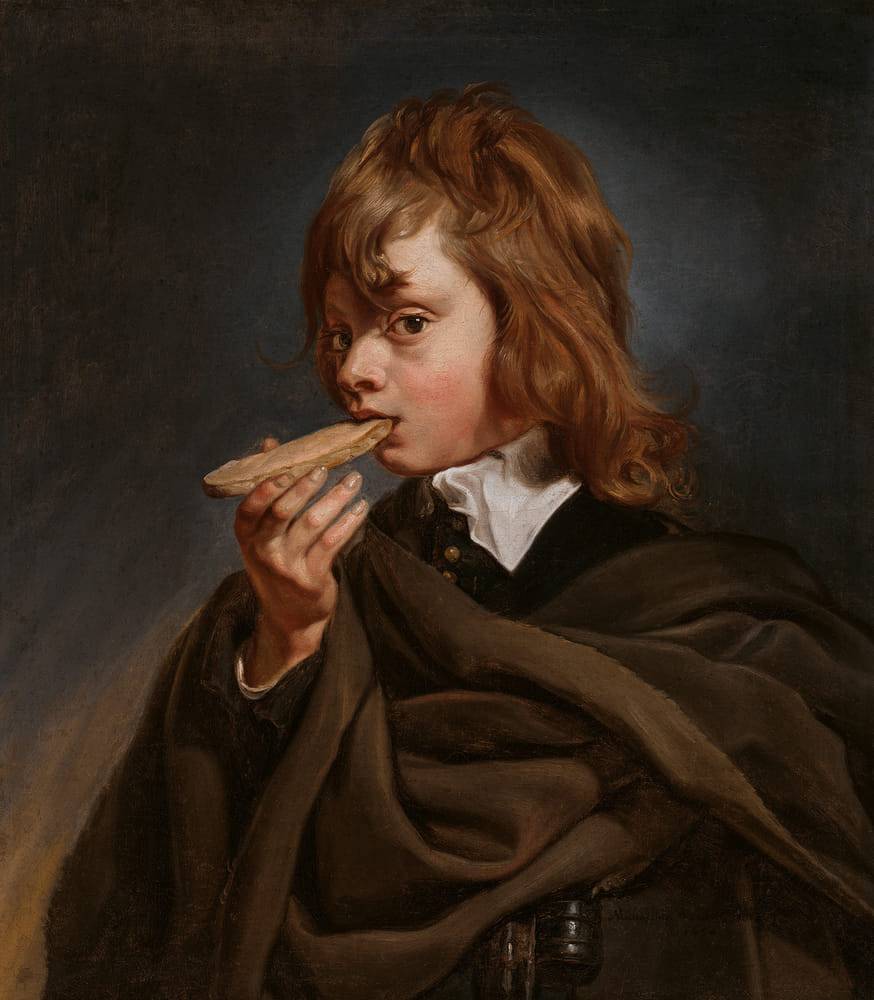 A young man with curly blond hair holds a piece of bread near his mouth. He is wearing a dark cloak and a white shirt. His gaze is directed straight at the viewer and he appears to be pensive. The background is dark